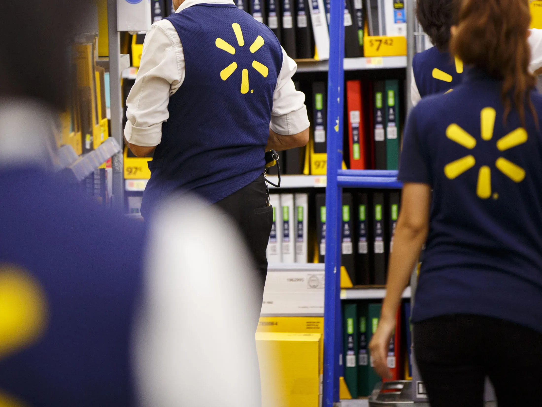 Employees restock shelves at a Walmart store.