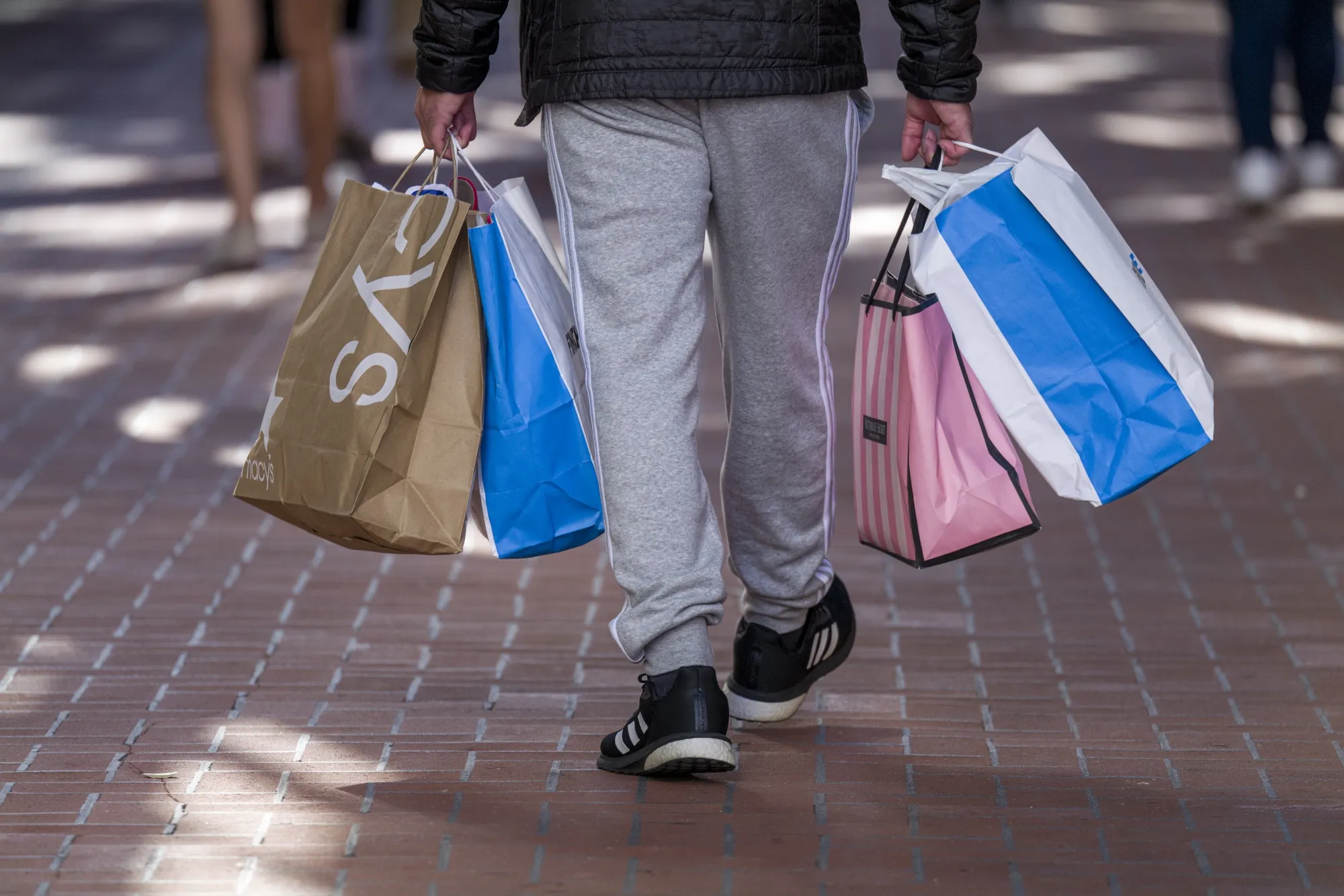 A pedestrian carries shopping bags in San Francisco, California.