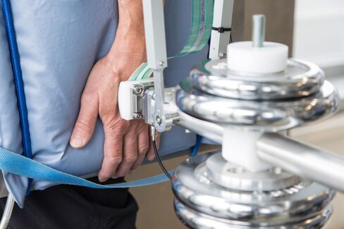 A mechanical pendulum impacts a human guinea pig's arm during pain threshold testing at the robot collision testing facility in the Fraunhofer Institute in Magdeburg, Germany.