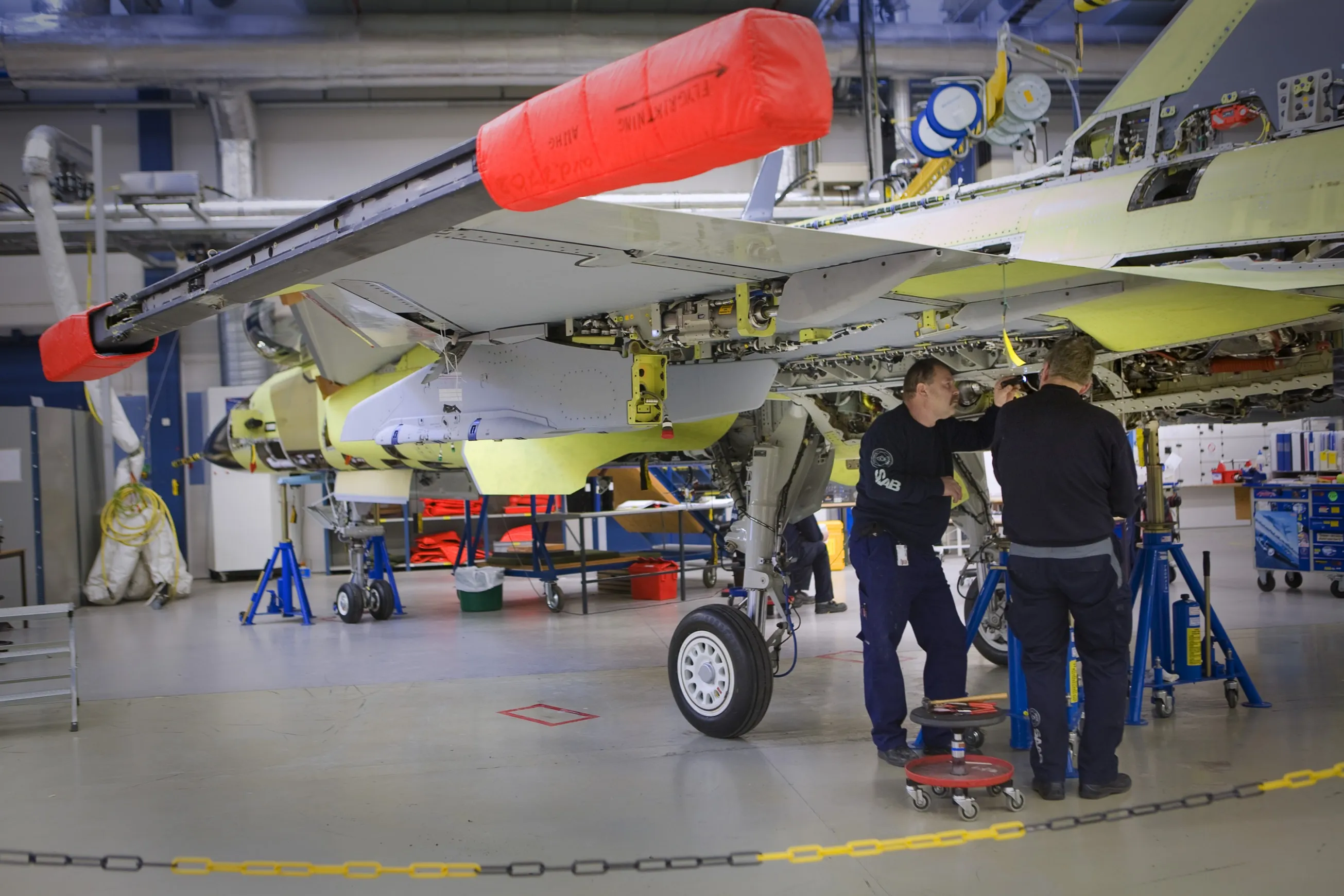 Employees assemble&nbsp;a Saab Gripen fighter jet at the company's factory in Linkoping, Sweden.