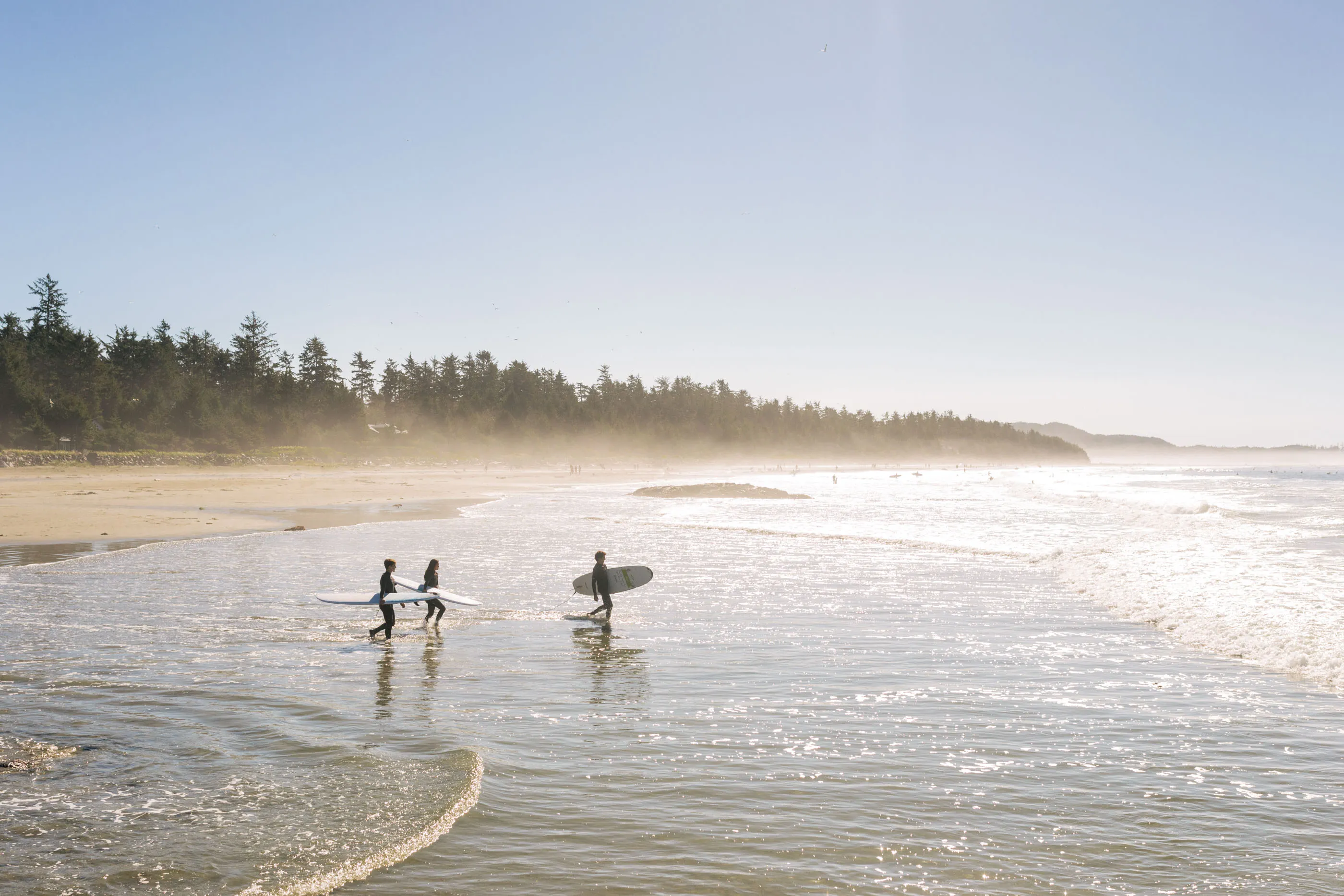 Two people enjoying a surf lesson in Tofino.
