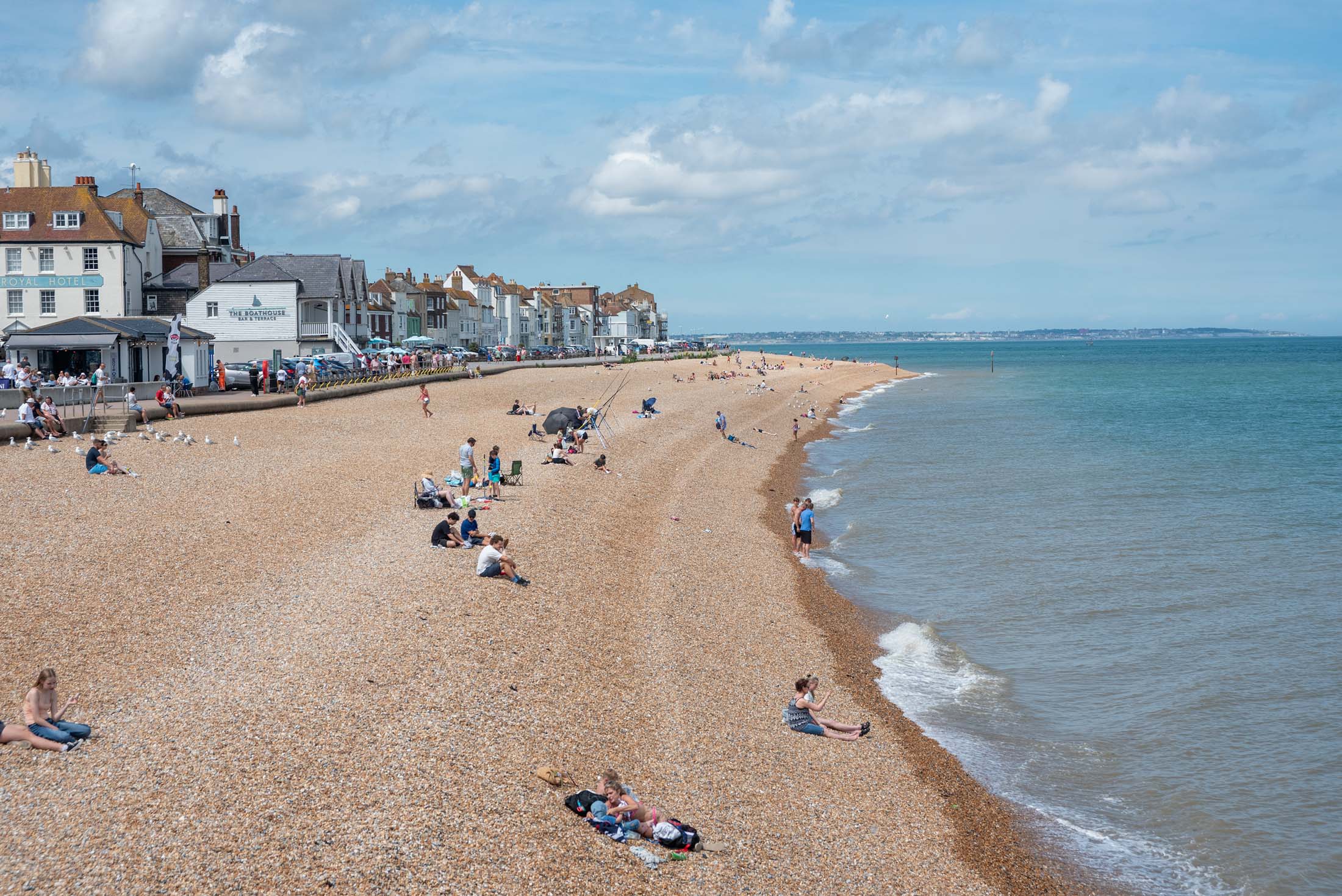Beachgoers enjoy the sun on the beach in Deal, Kent, which lies where the North Sea and the English Channel meet. 