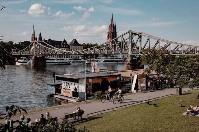 Visitors along the river Main in Frankfurt.
