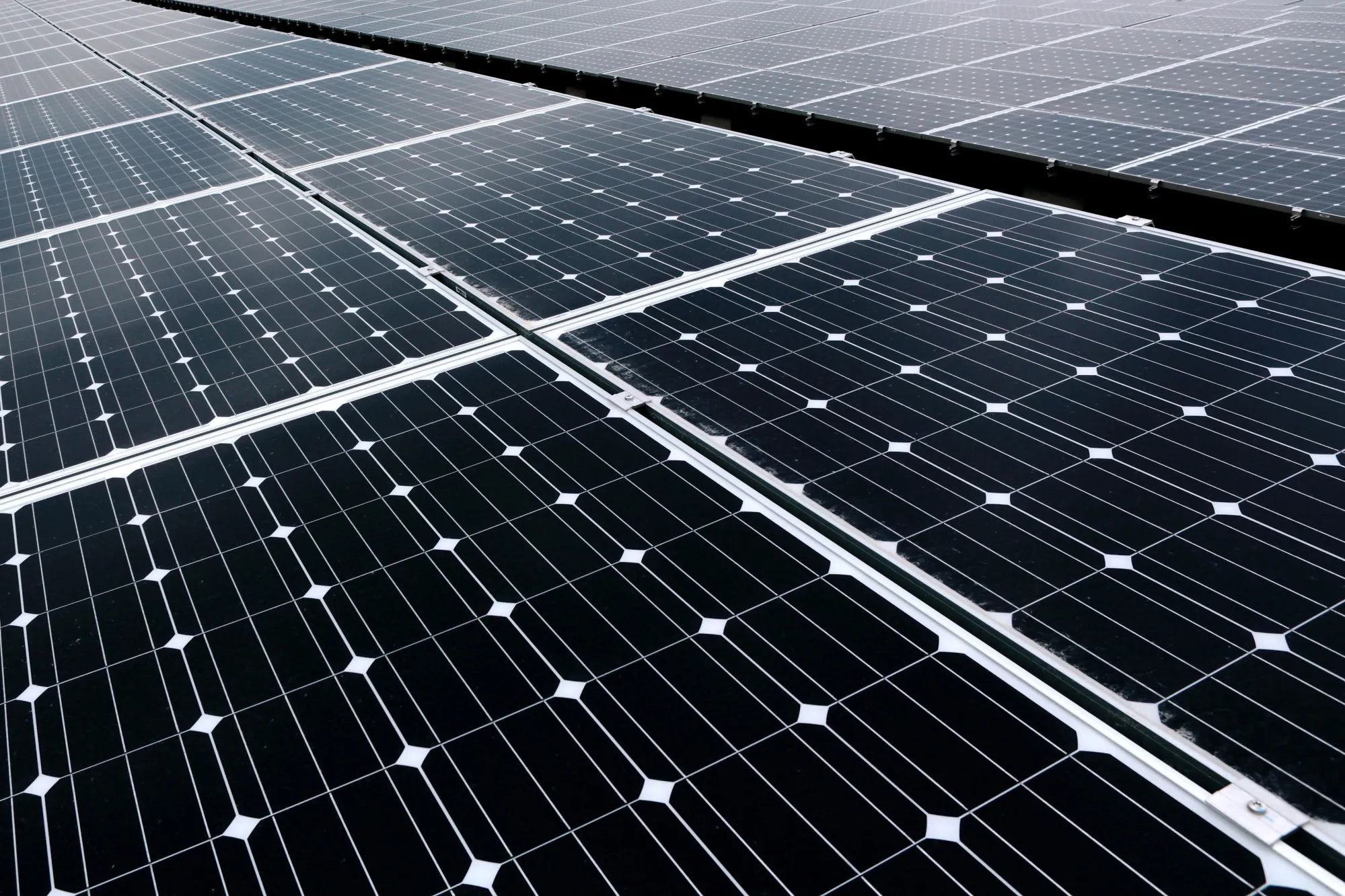 Solar panels stand at the SoftBank Takasago Solar Park, operated by SoftBank Corp.'s unit SB Energy Corp., in Takasago City, Hyogo Prefecture, Japan, on Tuesday, Feb. 18, 2014. Average system costs for non-residential solar projects have fallen 1.8 percent to 275,000 yen per kilowatt, the Ministry of Economy, Trade and Industry said in a document today.