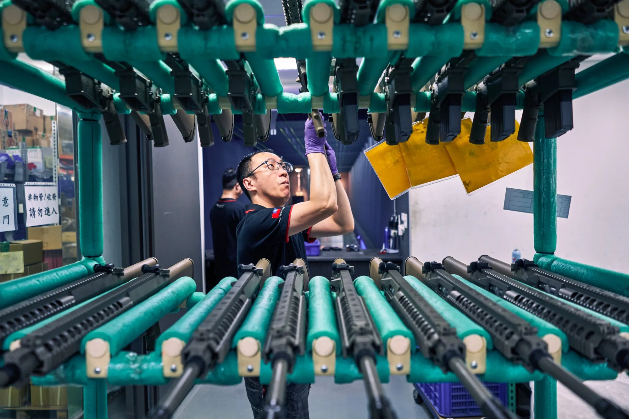 Employees inspect rifles at a factory for&nbsp;airsoft gun manufacturer&nbsp;Vega Force Company.&nbsp;