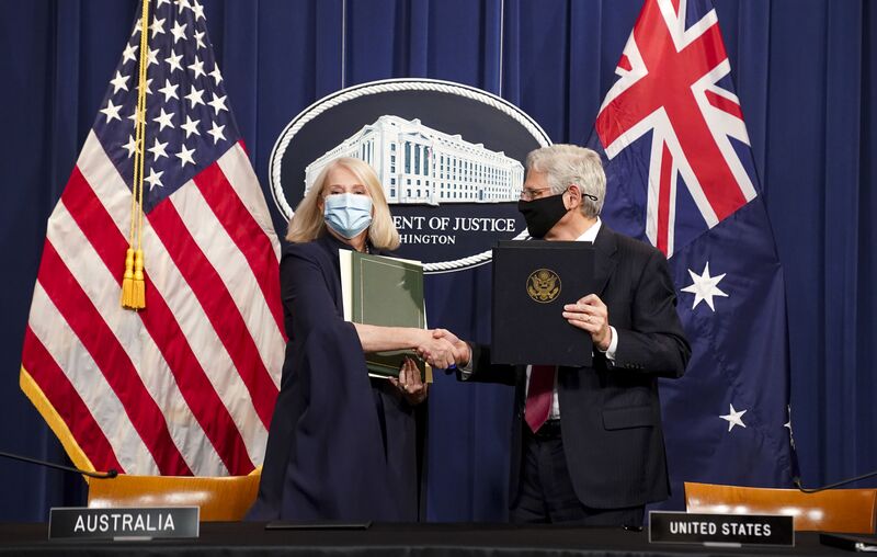 Merrick Garland, U.S. attorney general, right, shakes hands with Karen Andrews, Australia's minister for home affairs, during an event in Washington, D.C., on Dec. 15. 