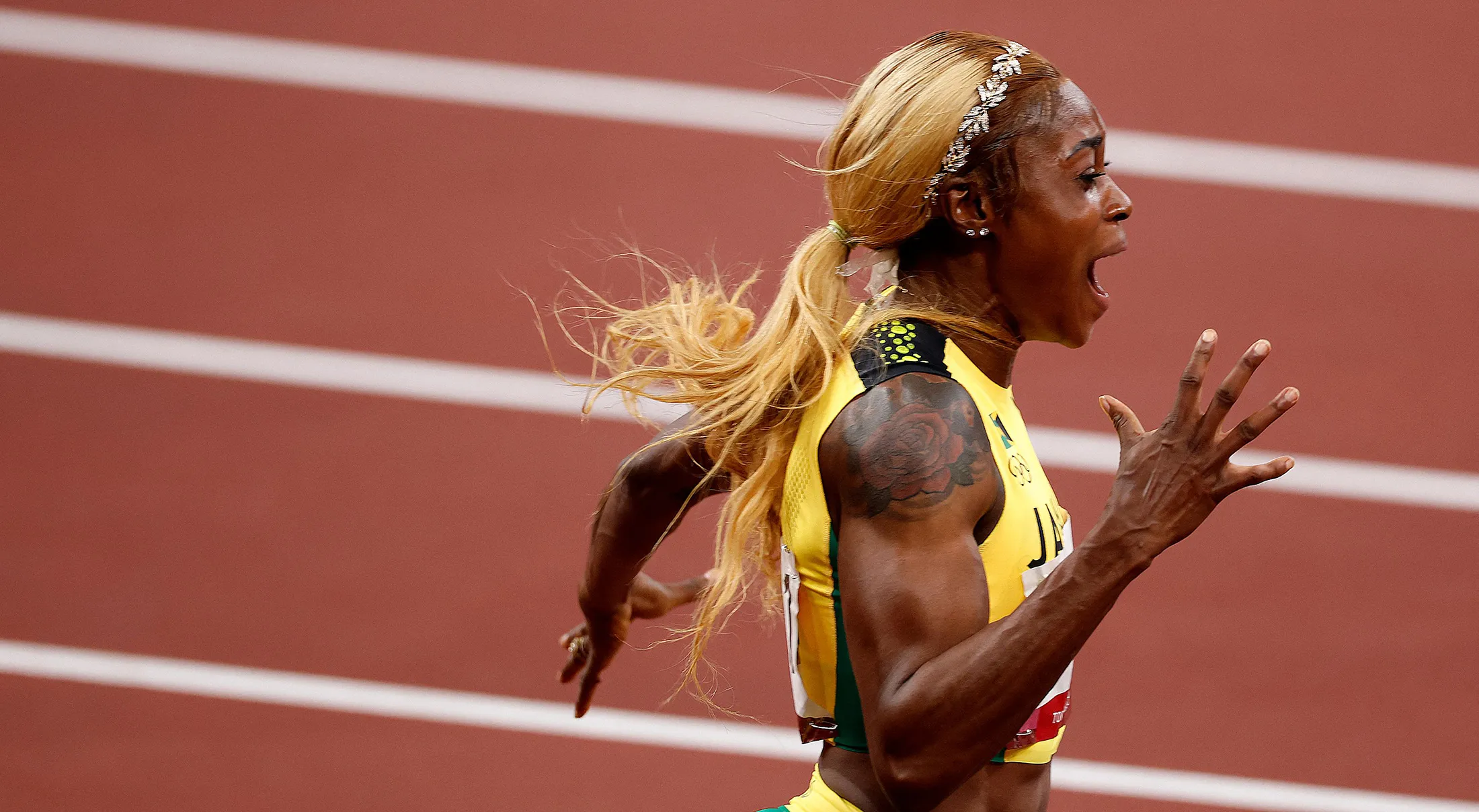 Elaine Thompson-Herah celebrates after winning the women's 100m final and setting a new Olympic Record during the Tokyo 2020 Olympic Games on July 31.