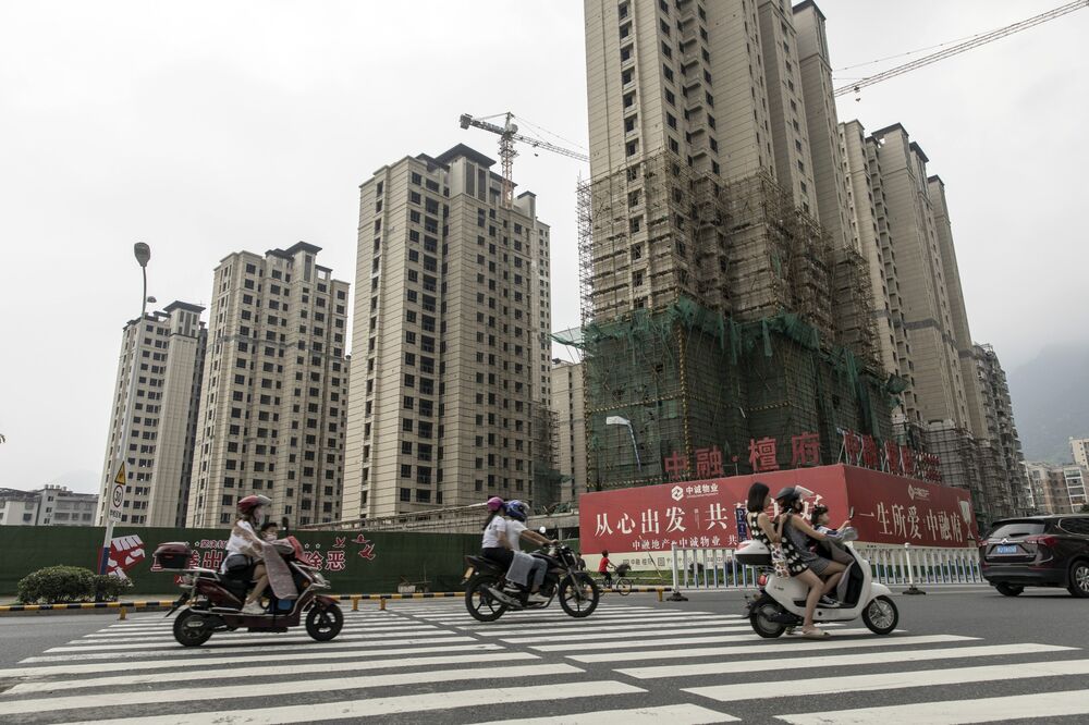 Motorists travel past residential buildings under construction in Ningde, Fujian province, China.