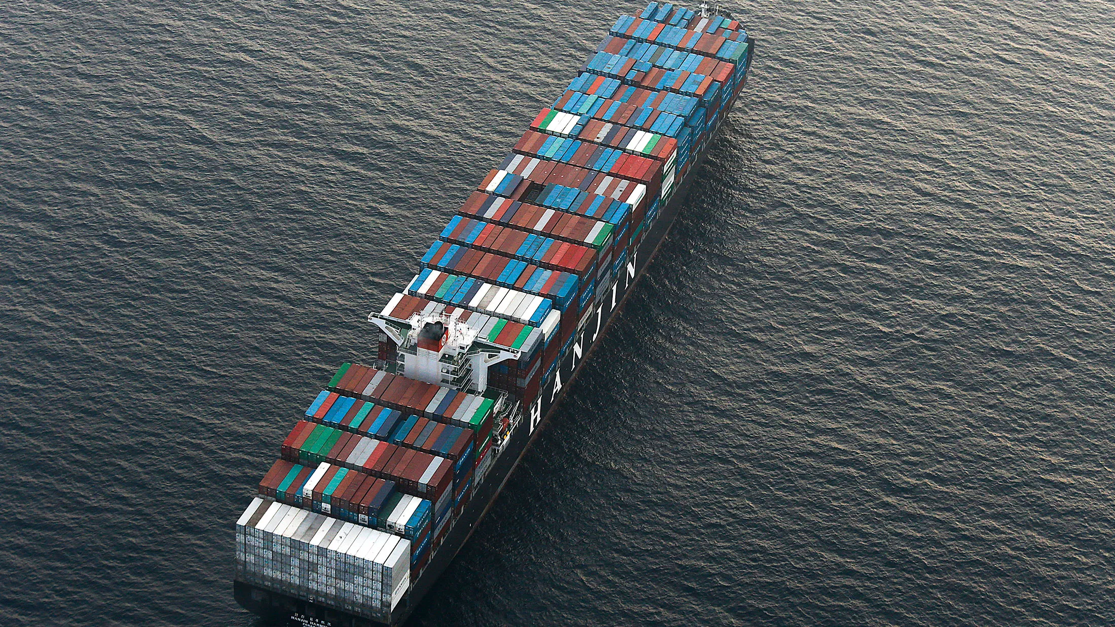 A container ship waits to unload cargo near the Port of Los Angeles.
