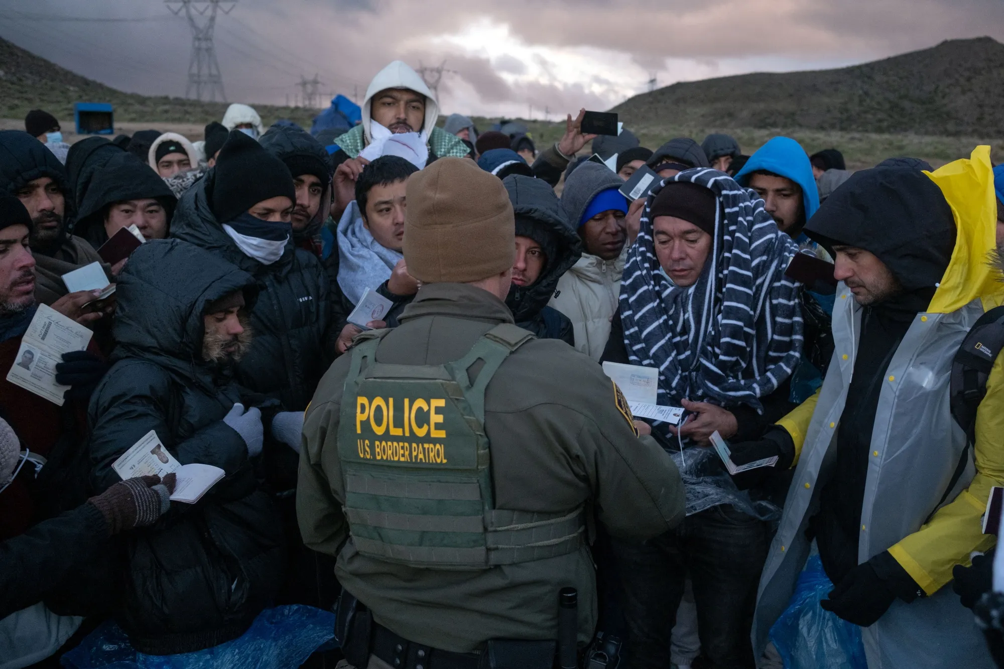 Asylum seekers rush to be processed by border patrol agents&nbsp;near the US-Mexico border in Jacumba, California.