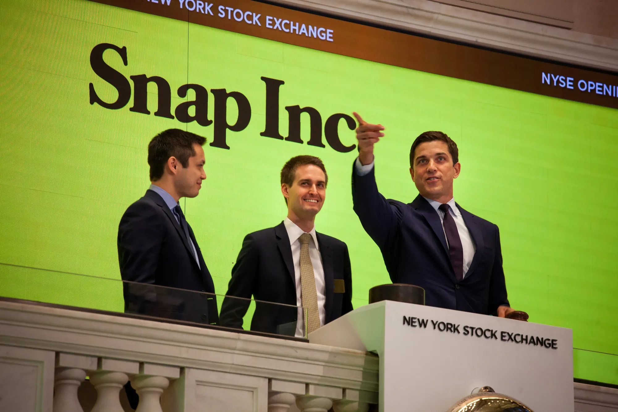 (From left) Bobby Murphy, co-founder and chief technology officer at Snap Inc., Evan Spiegel, co-founder and chief executive officer of Snap Inc., ring the opening bell at the New York Stock Exchange (NYSE) with Tom Farley, president of the NYSE Group, during the company\'s initial public offering (IPO) in New York, U.S., on Thursday, March 2, 2017.