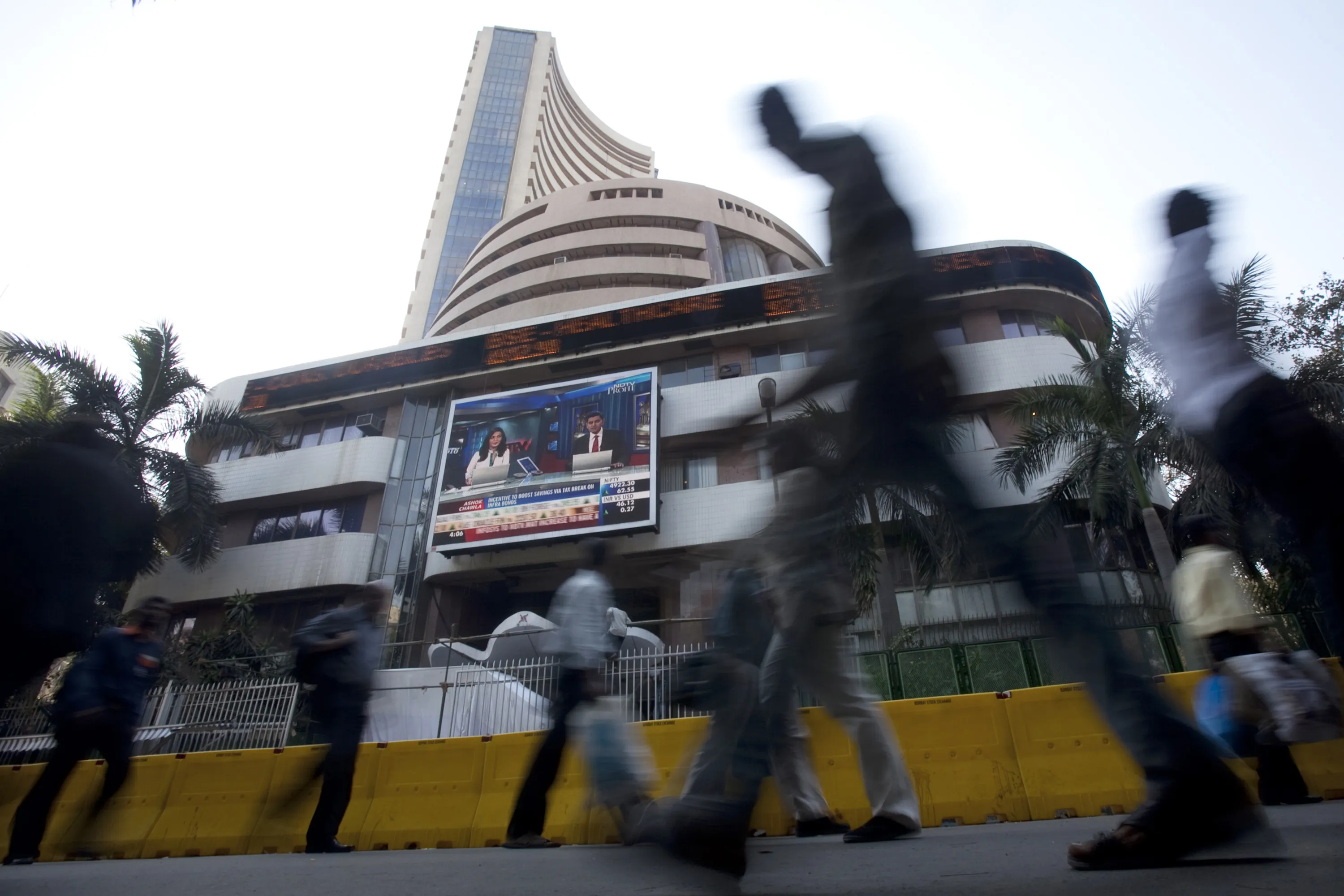 Pedestrians walk past the Bombay Stock Exchange building in Mumbai.