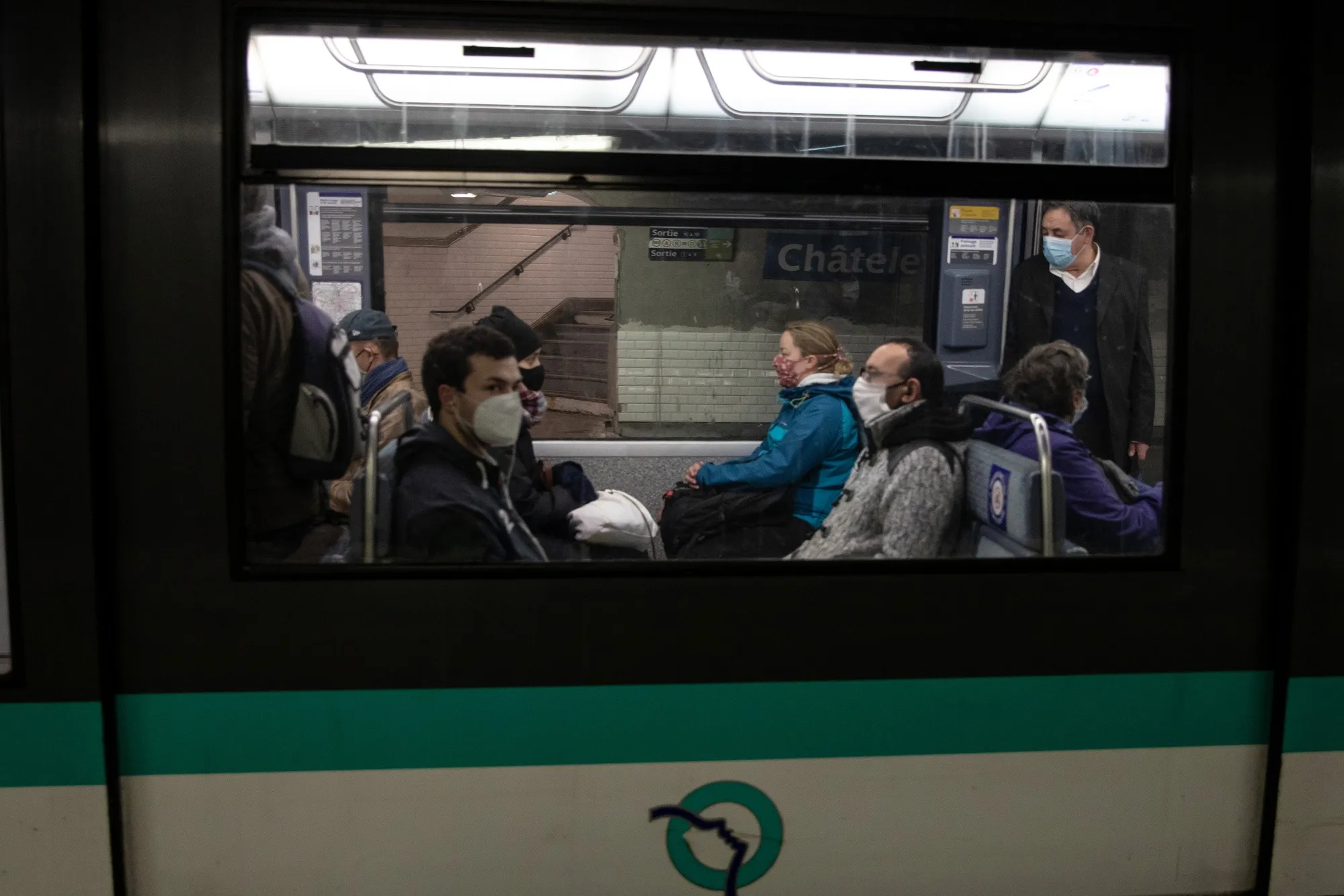 Commuters sit on a metro train at Chatelet-Les-Halles station in Paris, on May 11.