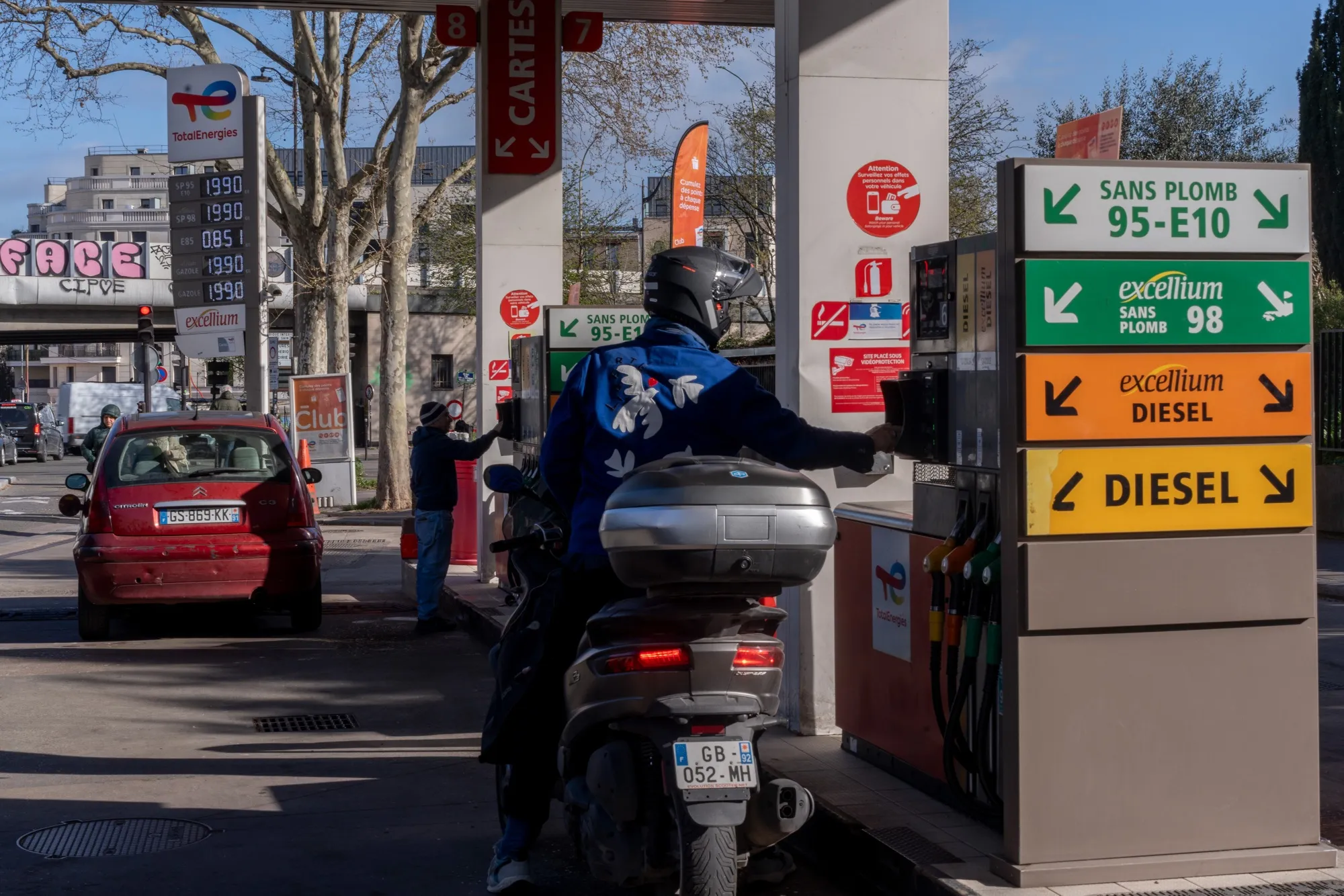 Drivers refuel their vehicles at a gas station in Paris.