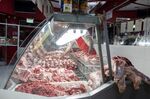 A worker arranges cuts of beef at a butcher's shop in Buenos Aires.