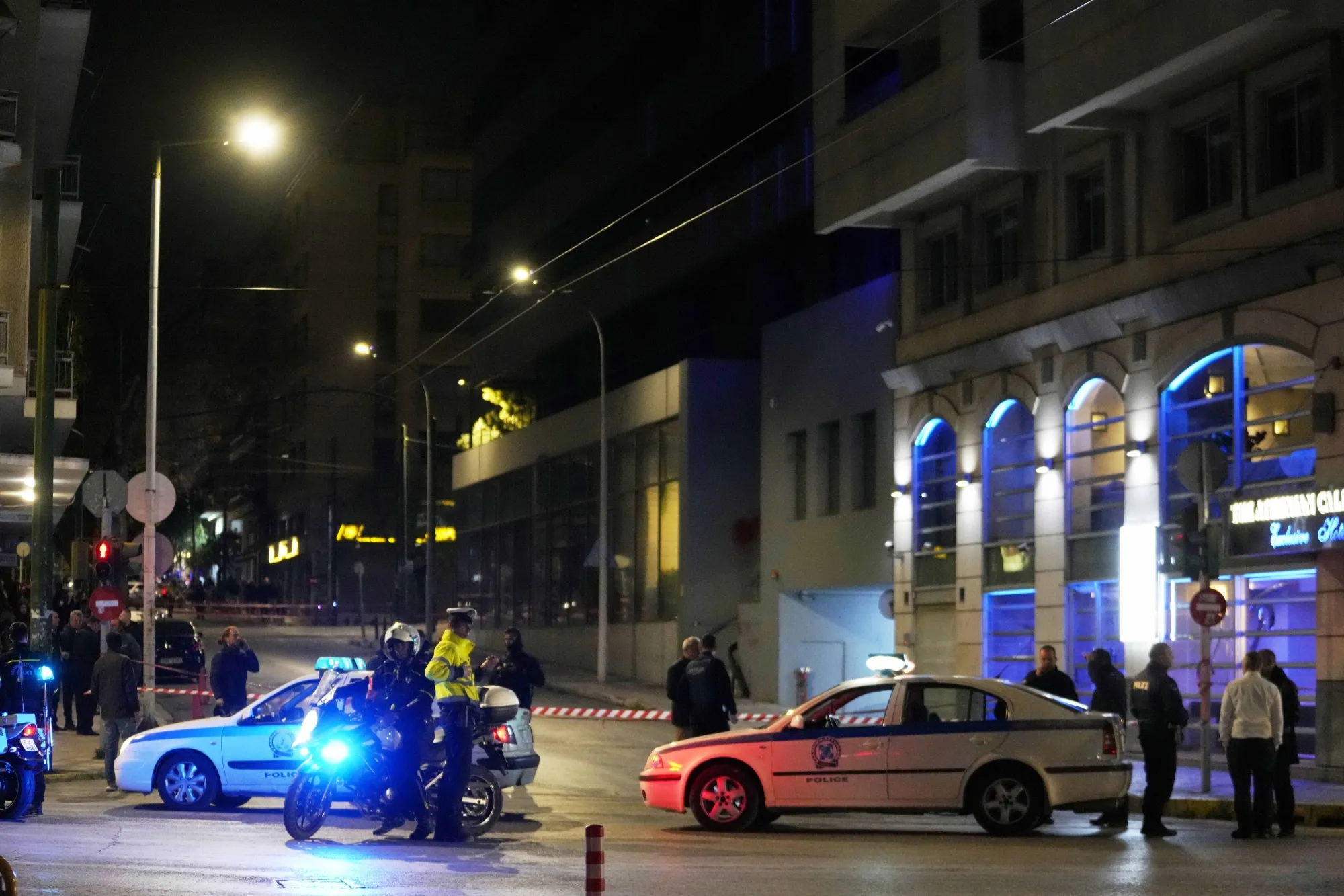 Policemen close the road after a suspected bomb explosion outside the Hellenic Train offices in Athens, Greece, on April 11.