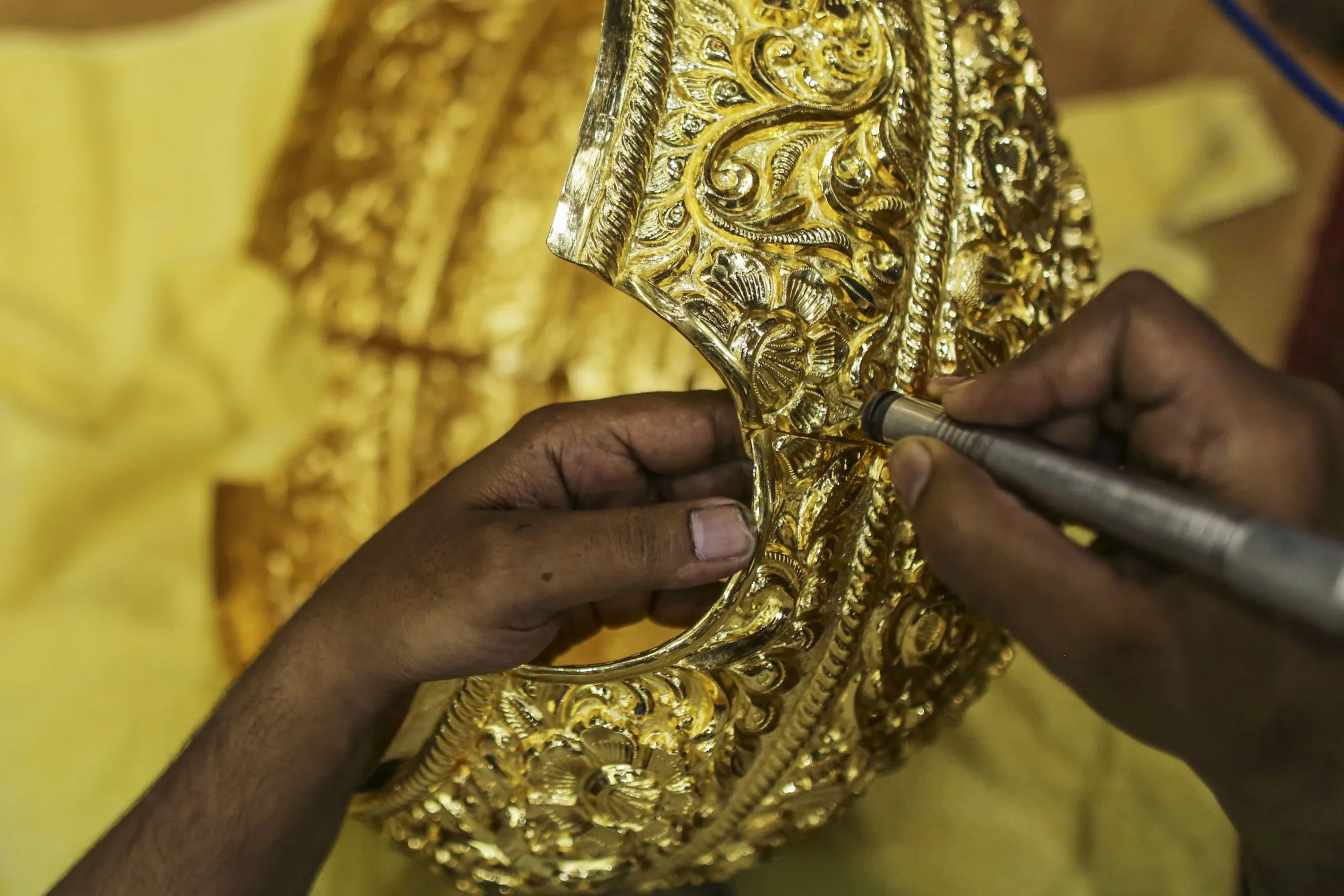 A worker labors on a six kilogram gold crown ahead of the Ganesh Chaturthi festival at a P.N. Gadgil Jewellers Pvt. workshop in Pune, India, on Monday, Aug. 17, 2017. About three quarters of the estimated $45 billion of the precious metal that is traded in the country each year makes its way through thousands of family-run jewelry shops that have catered for centuries to the nation's love of gold.