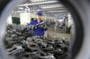 A Chinese worker checks auto parts on the assembly line at a factory in China's Jiangxi province.