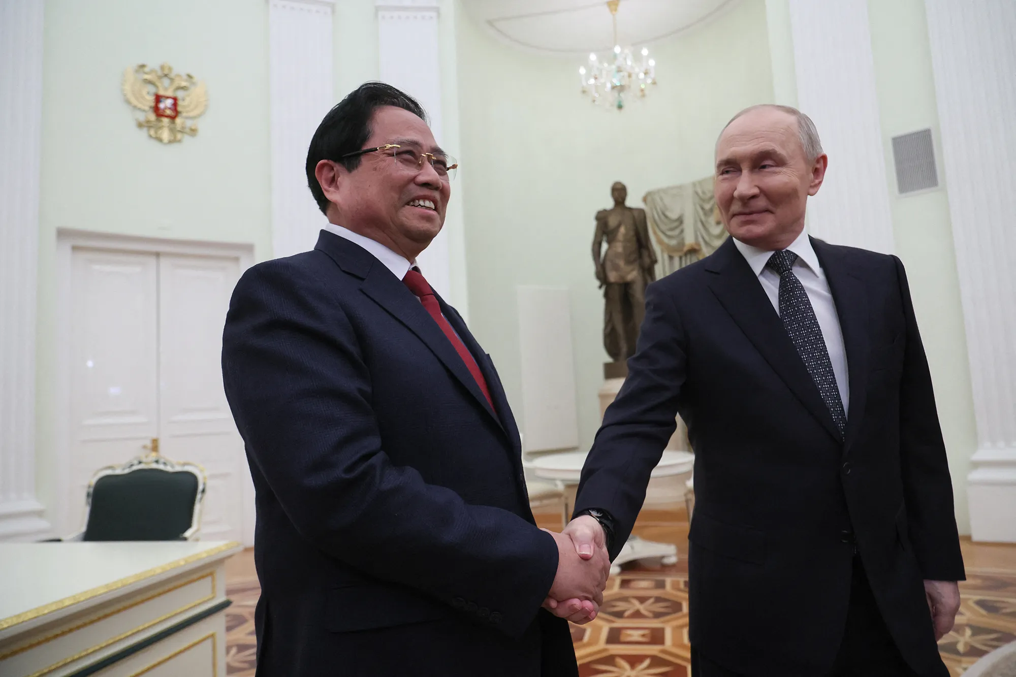 Russian President Vladimir Putin welcomes Vietnamese Prime Minister Pham Minh Chinh at the Kremlin in Moscow on March 25.