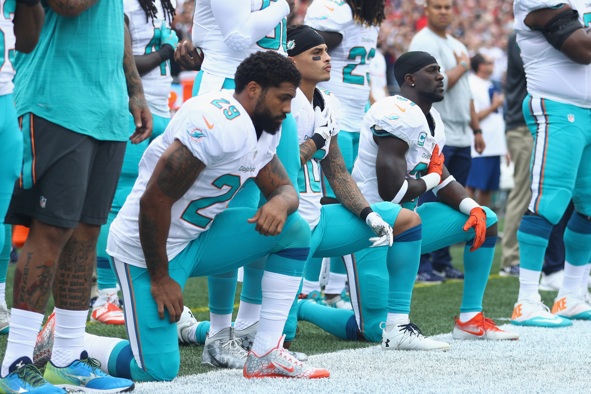 Fans burn Dolphins jerseys to protest anthem kneeling