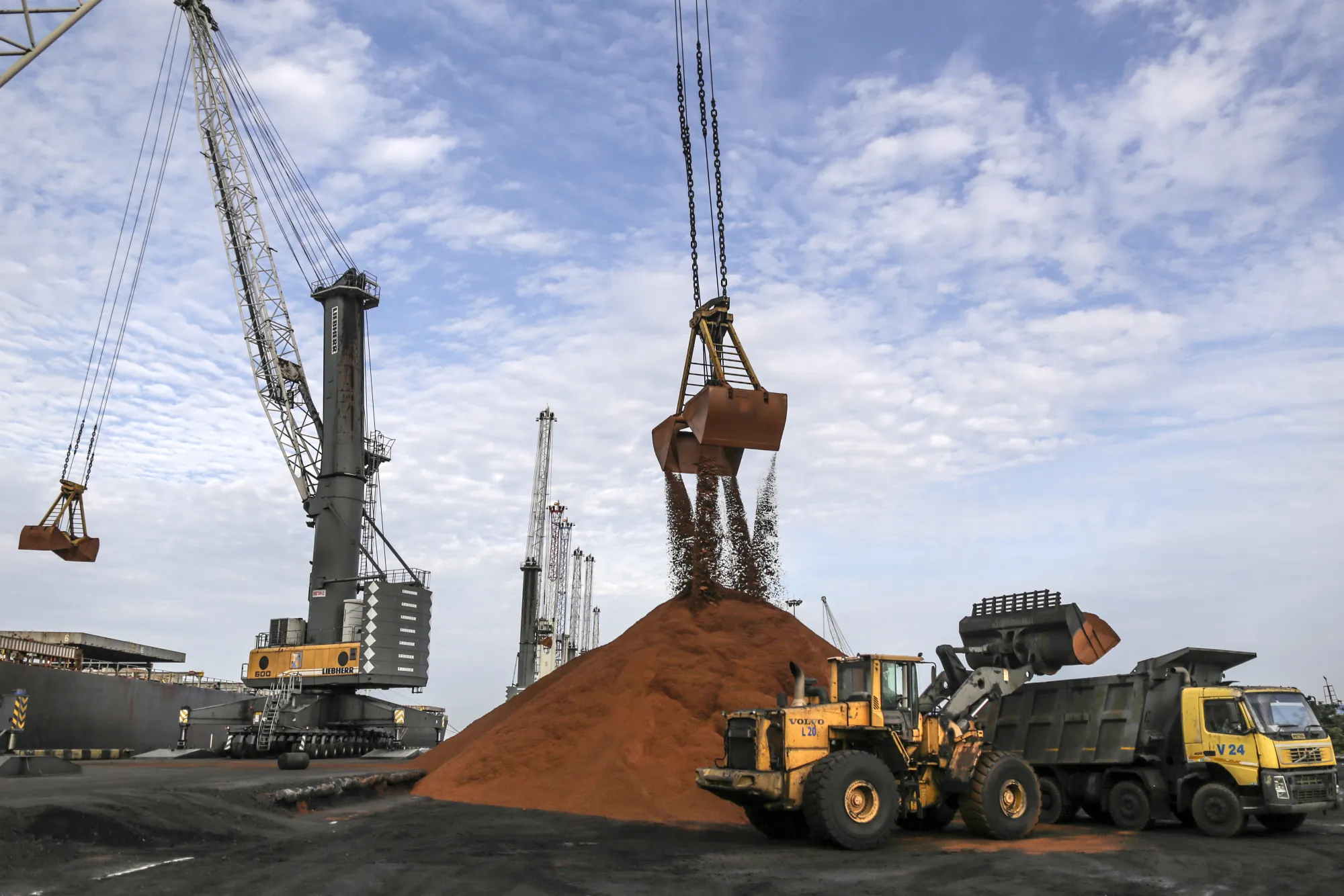 Cranes unload iron ore from a ship&nbsp;in Krishnapatnam, Andhra Pradesh, India.
