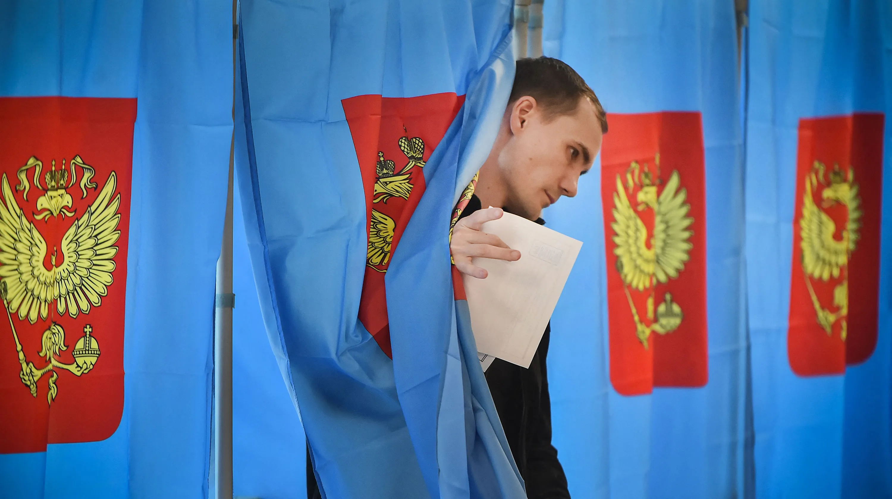 A man exits a voting booth on the first day of local elections in Russia, at a polling station in Novosibirsk, Siberia, Russia, on Sept. 8.