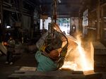 Molten steel is poured from a ladle into a large mold at a castings facility in Salem, Ohio.