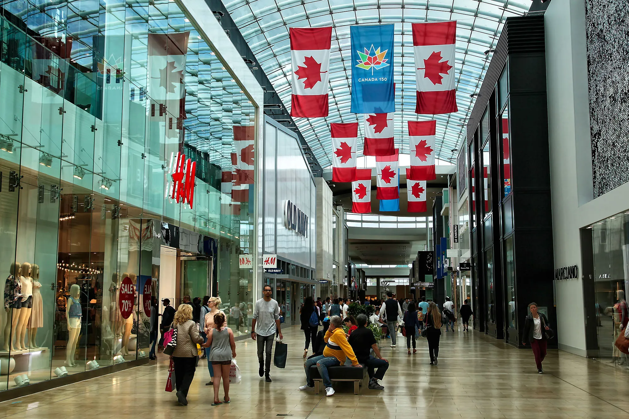 Shoppers walk through a mall in Canada.
