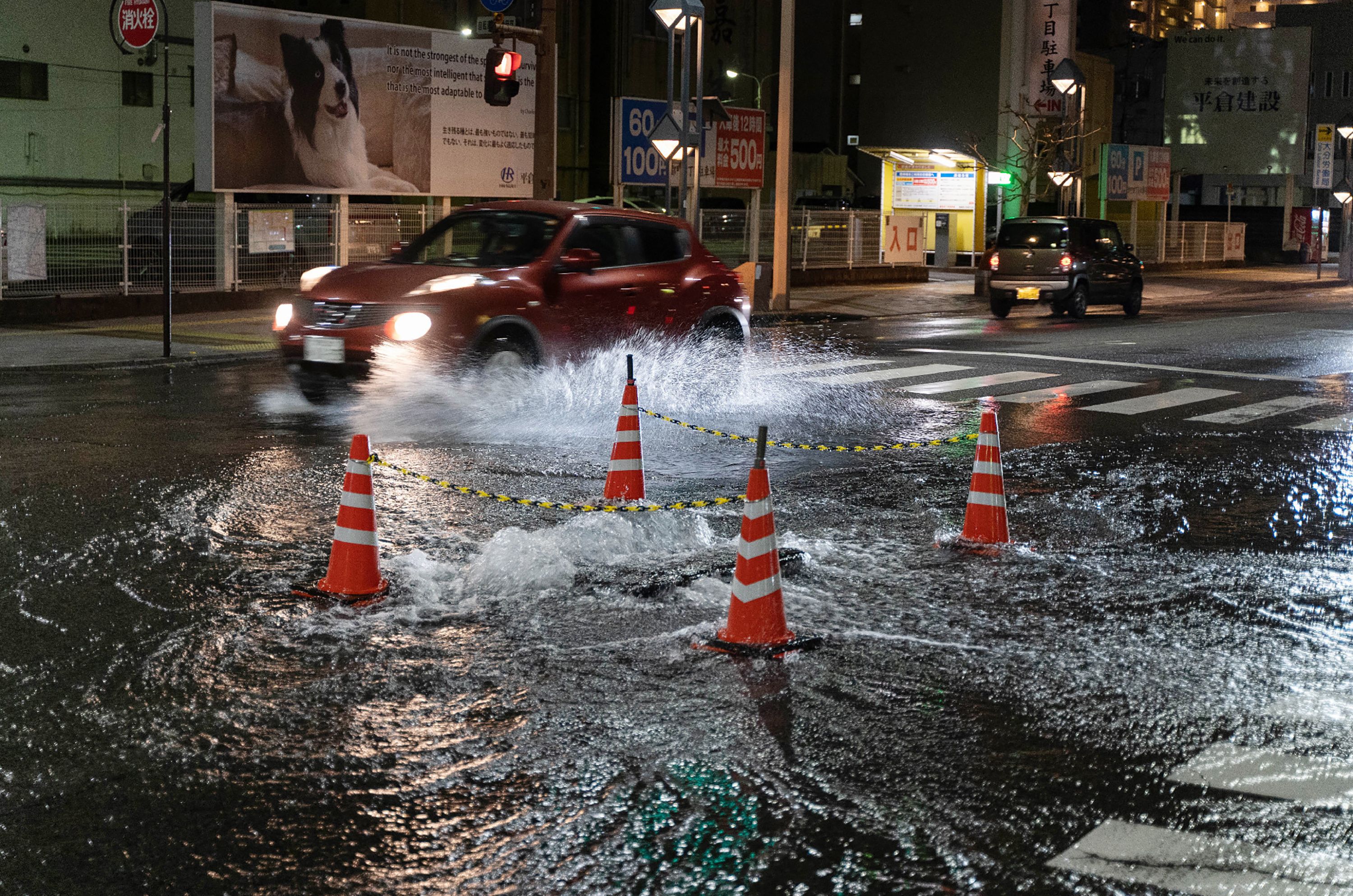 Water flowing from a manhole floods an intersection in Oita early on Jan.&nbsp;22.