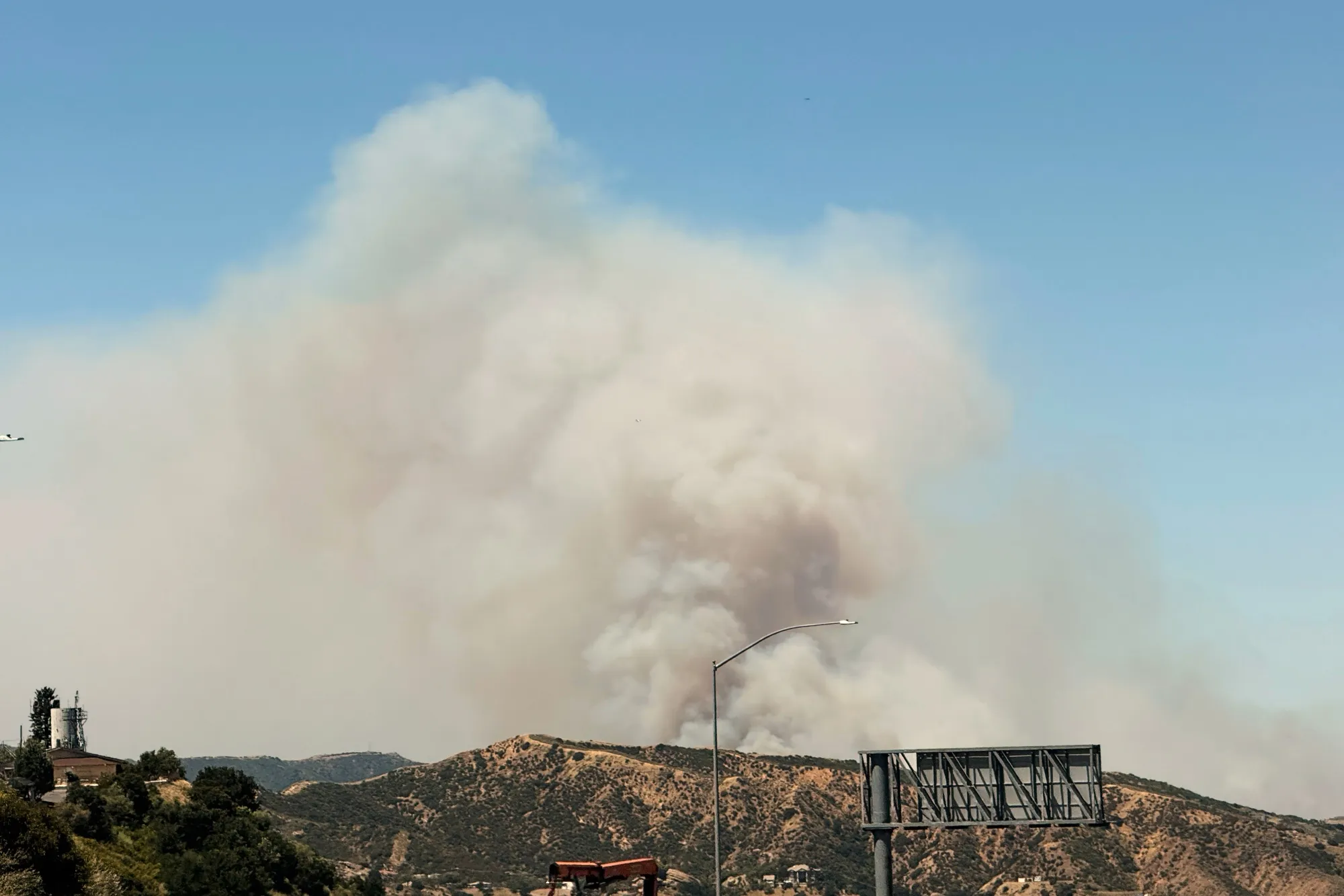 A plume of smoke from the Sandy Fire rises over a hilltop in Simi Valley, California on May 18.&nbsp;