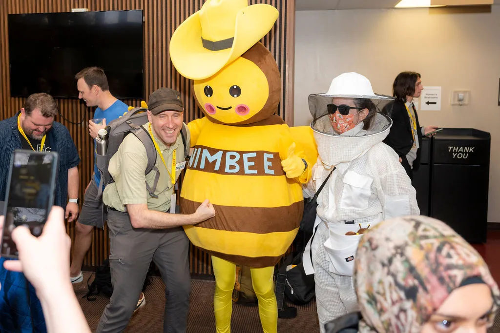 YIMBYtown attendees in Austin pose with their archnemesis, the NIMBEE.&nbsp;
