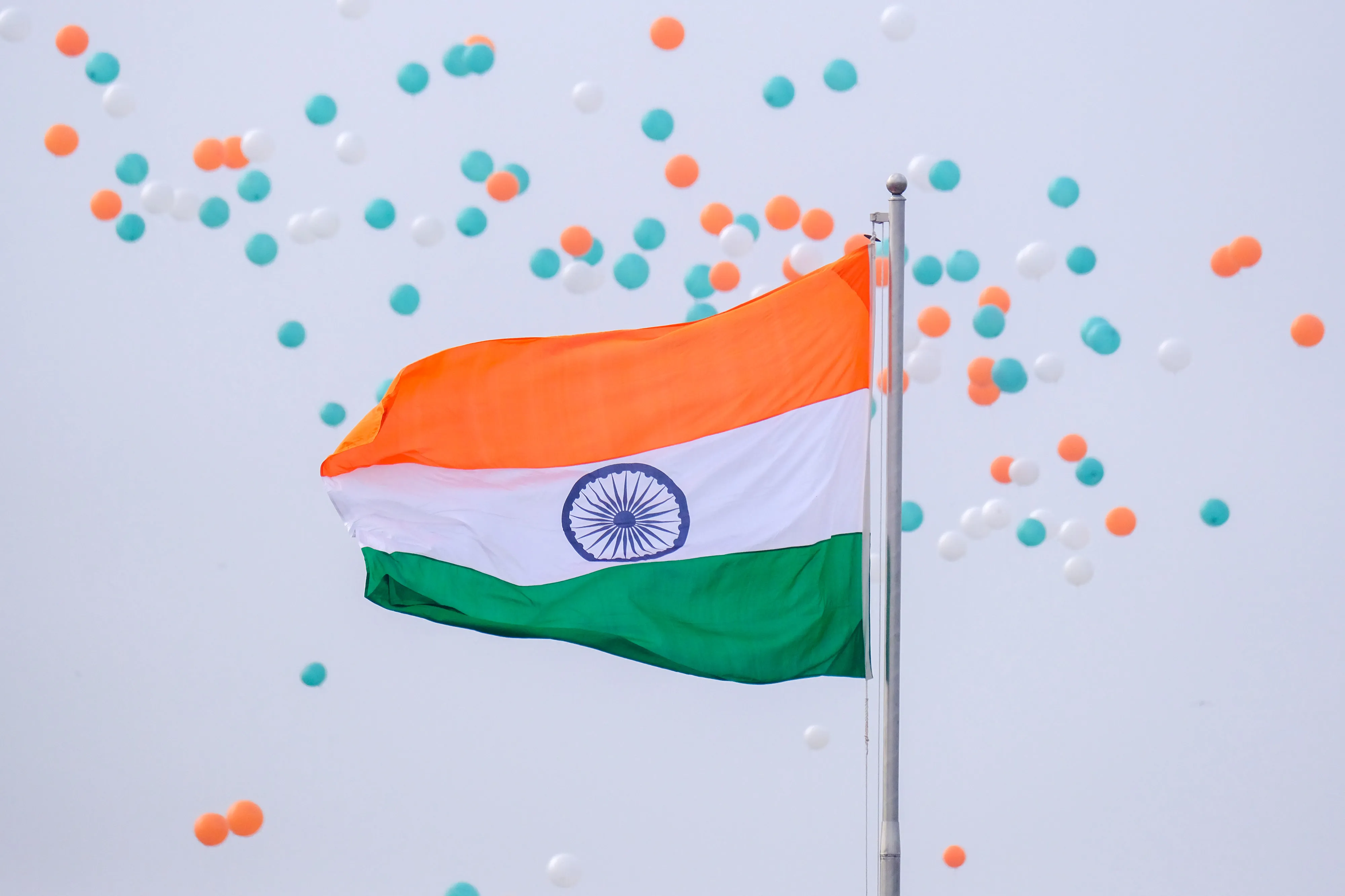 Balloons float past an Indian national flag in New Delhi, India.