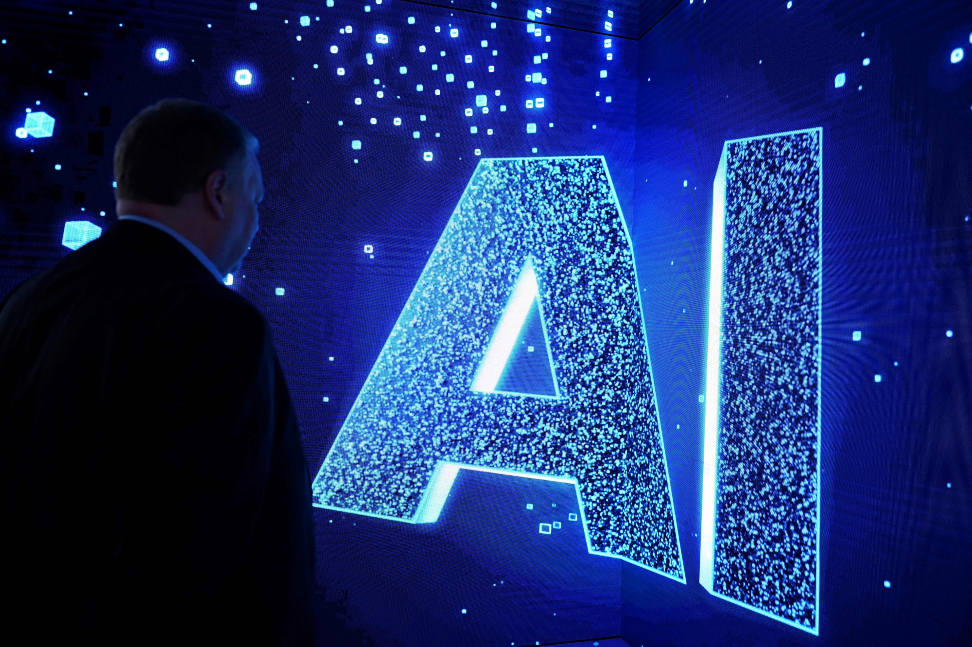 A visitor watches an AI sign at the Mobile World Congress&nbsp;in Barcelona, Spain.