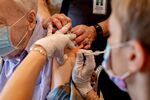 A healthcare worker administers a third dose of the Pfizer-BioNTech Covid-19 vaccine at a senior living facility in Worcester, Pennsylvania, U.S., on Wednesday, Aug. 25, 2021. 