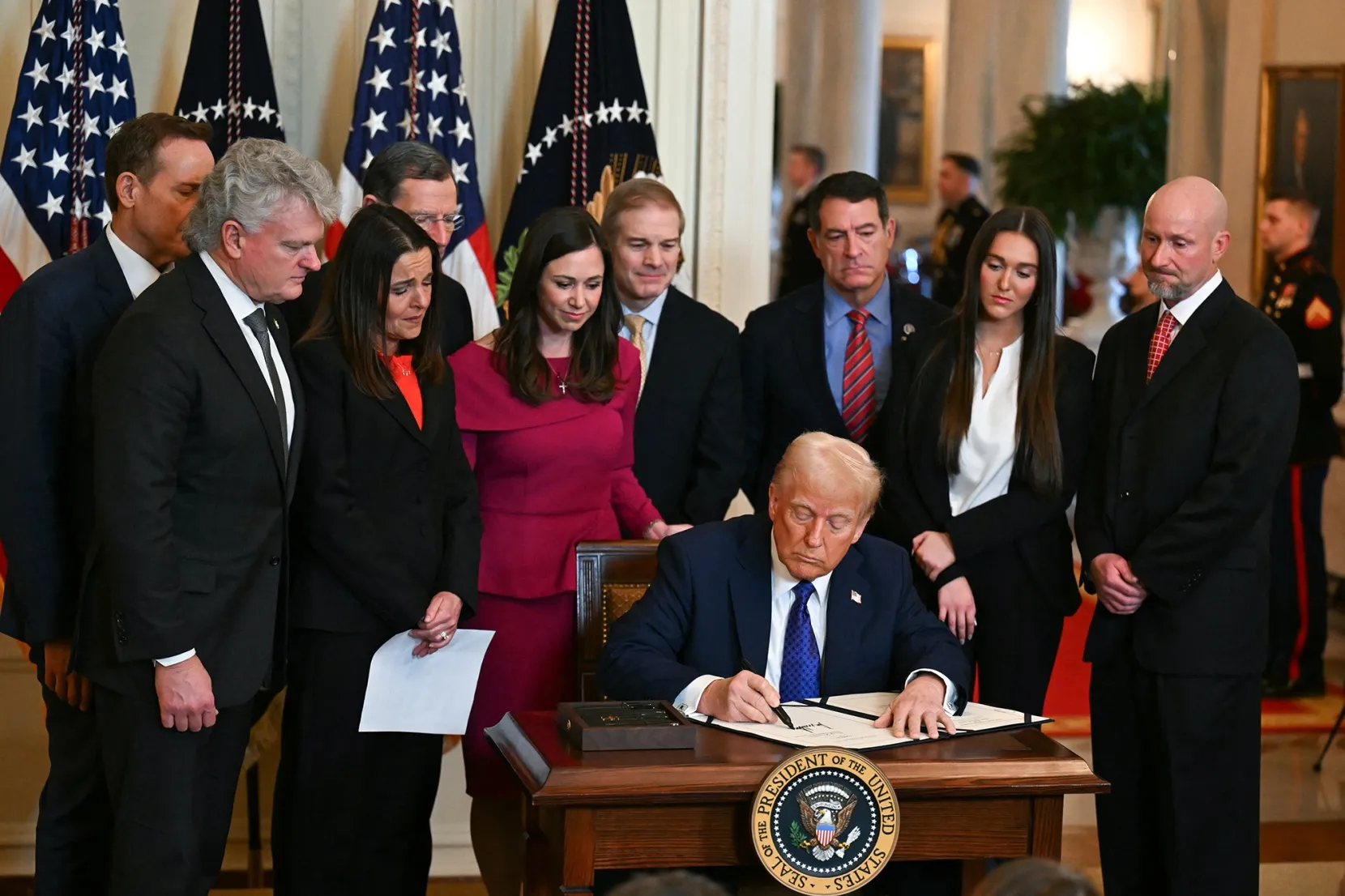 Donald Trump signs the Laken Riley Act.