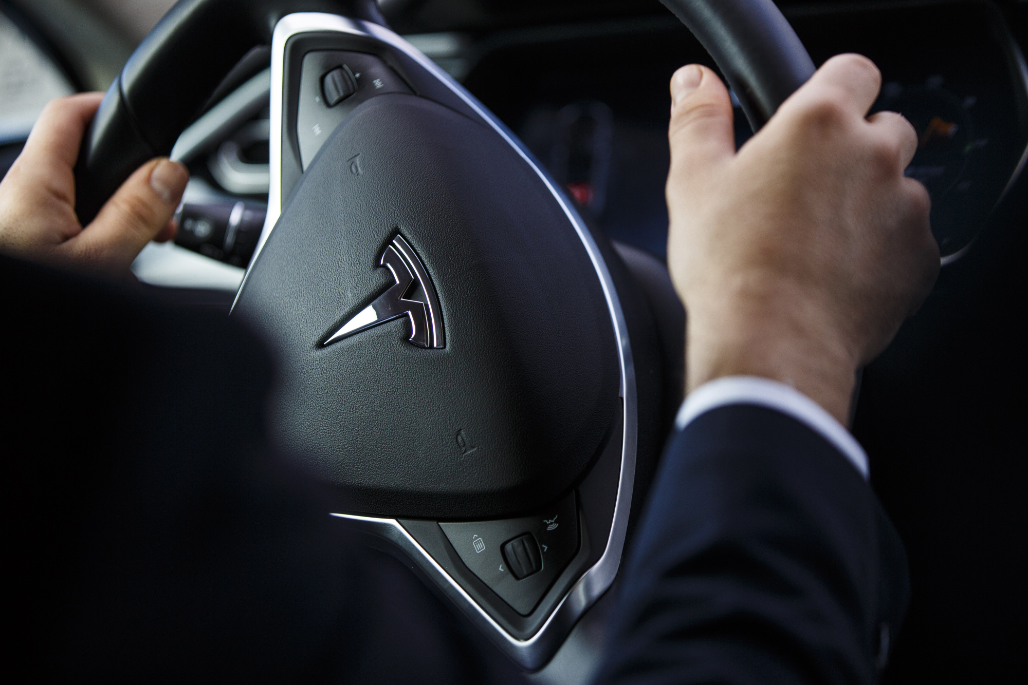 The Tesla logo on&nbsp;the steering wheel of an Uber Tesla Model S electric automobile.