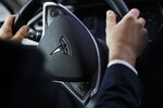 The Tesla logo on&nbsp;the steering wheel of an Uber Tesla Model S electric automobile.
