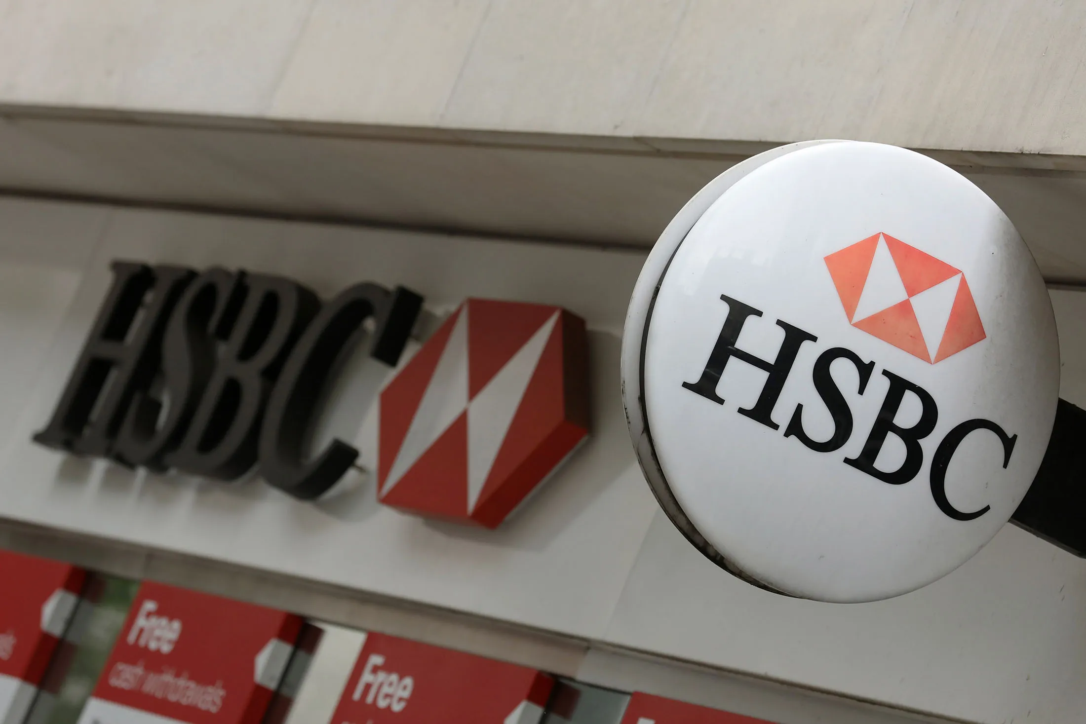 A logo sits outside a HSBC Holdings Plc bank branch in London, U.K., on Tuesday, May 2, 2017.
