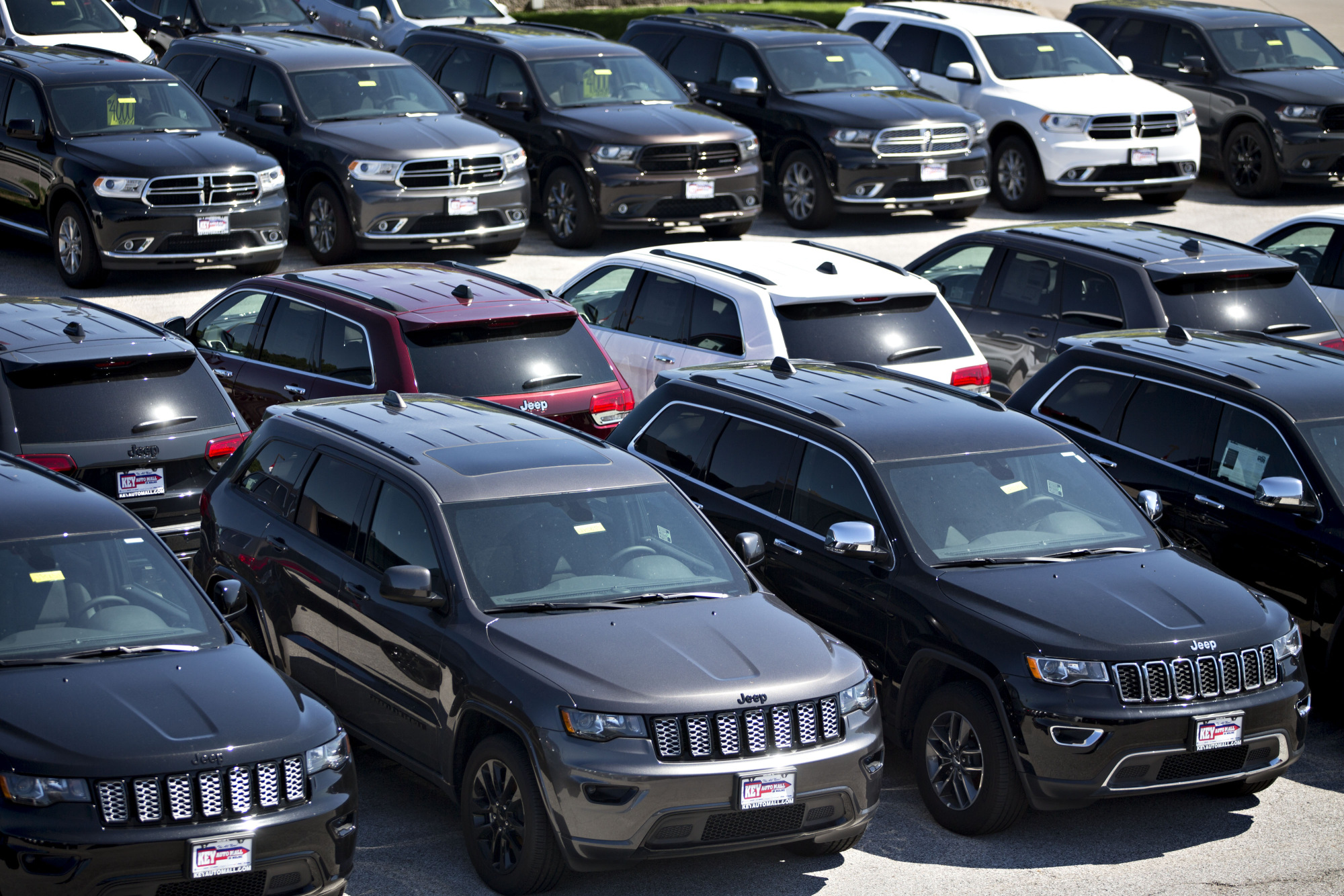 Jeep and Dodge vehicles are displayed for sale at a Fiat Chrysler Automobiles (FCA) car dealership in Moline, Illinois.