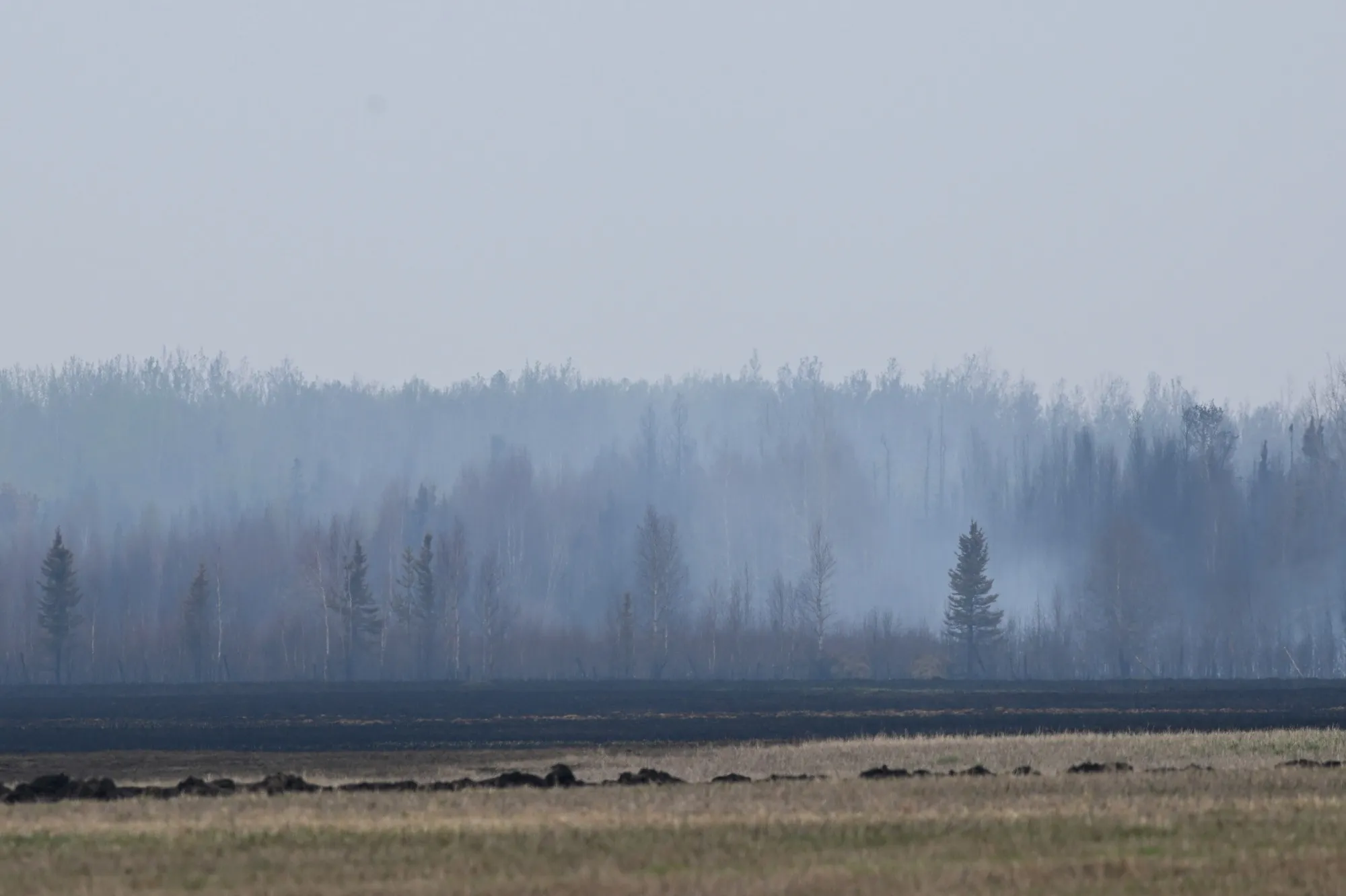 Smoke billows from a still-smoldering fire outside of Drayton Valley, Alberta on May 8.&nbsp;