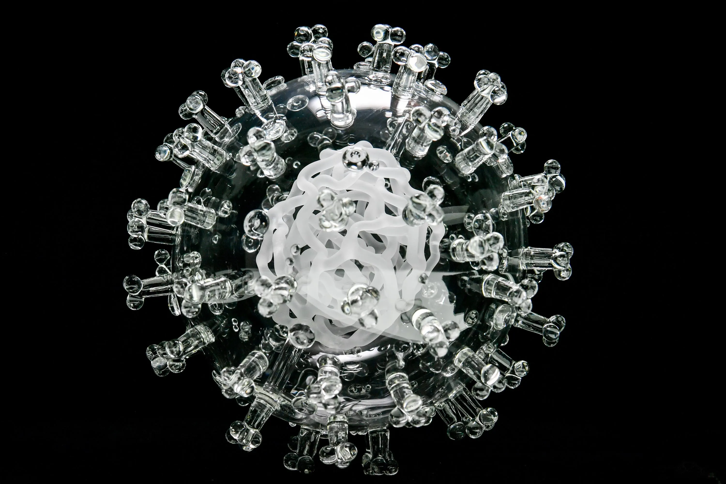 A glass sculpture of the coronavirus.