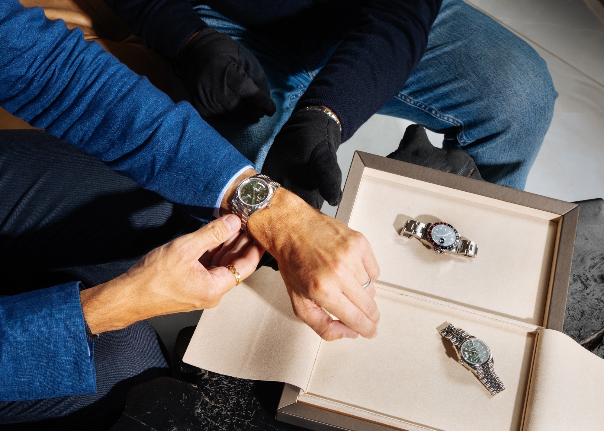 A man tries on a Rolex watch.