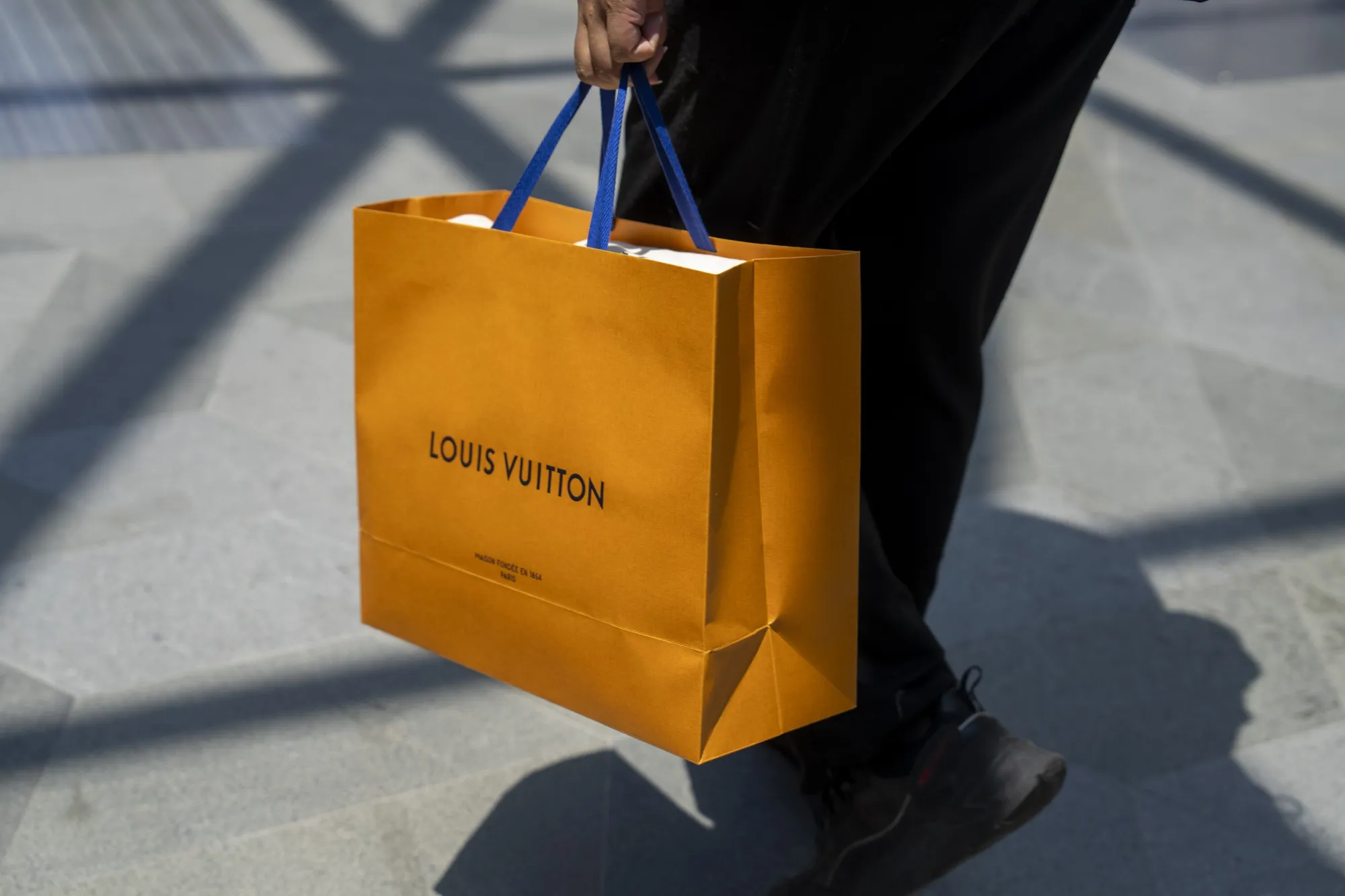 A shopper carries a Louis Vuitton bag in Shanghai.