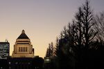 The National Diet building stands at dusk in Tokyo.