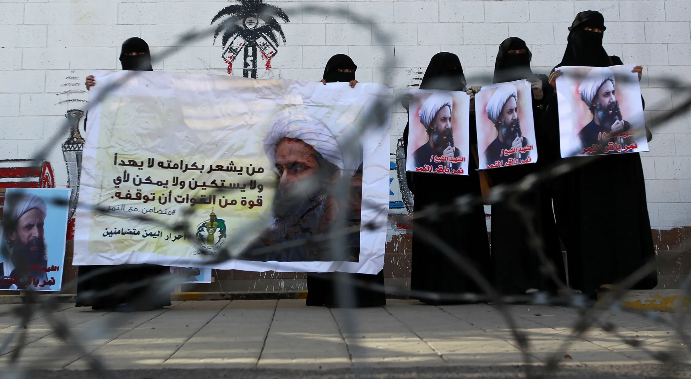 Yemeni women hold banners bearing portraits of prominent Shiite cleric Nimr al-Nimr during a demonstration outside the Saudi embassy in the capital Sanaa, on Jan. 7.

