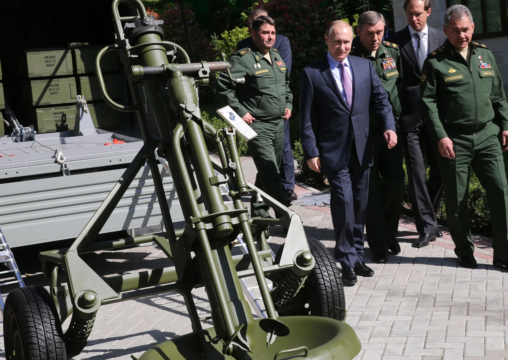 Russian President Vladimir Putin, center, observes military vehicles after a meeting with Defense Ministry officials in Sochi, Russia, on May 12, 2016.
