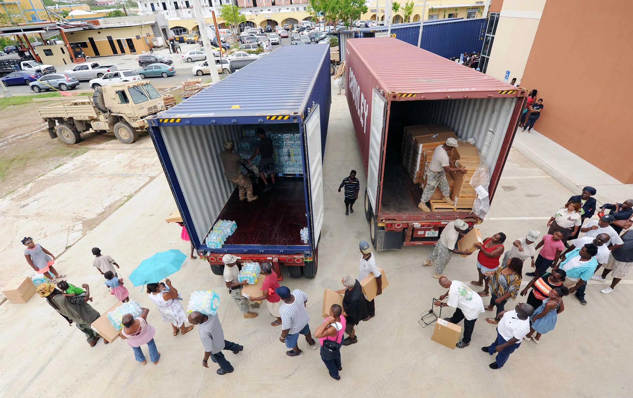 Volunteers and U.S. Virgin Islands National Guardsmen distribute hurricane-relief supplies to local residents on Oct. 10.