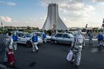 Volunteers disinfect automobiles at Azadi Square in Tehran on March 27.