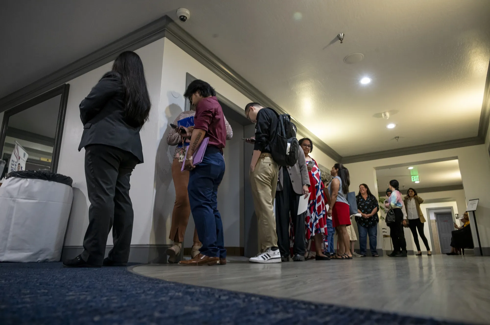 Attendees wait in line to enter a hiring event in Sacramento, California.