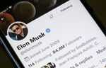 Elon Musk’s Twitter account is displayed on the screen of an iPhone.